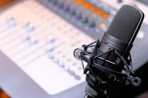 Microphone on mixing console background. recording concept